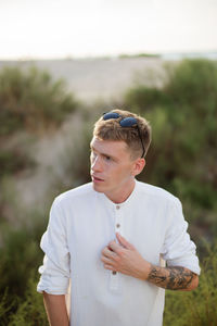 Portrait of young man standing outdoors