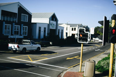 Cars on road along buildings