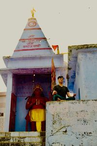 Portrait of temple against building