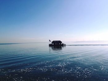 Boat on sea against clear sky