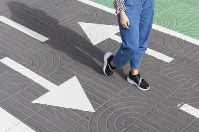 Young woman walking on road