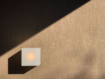 High angle view of illuminated lamp on wall
