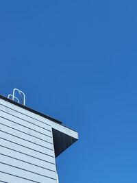 Low angle view of building against clear blue sky