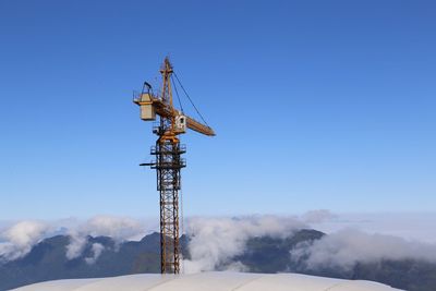 Communications tower against blue sky