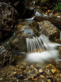 Stream flowing through rocks in forest