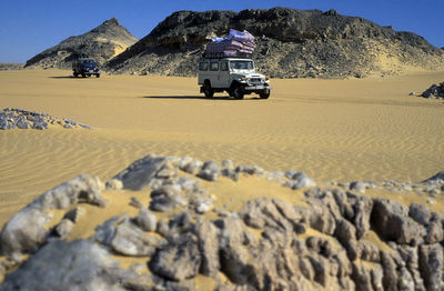 Land vehicles on desert landscape
