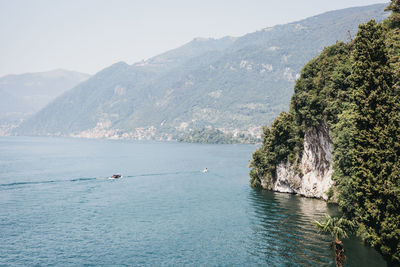 Scenic view of sea and mountains against sky