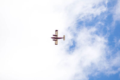 Low angle view of airplane in sky