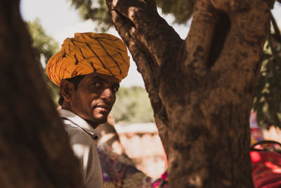 Portrait of man in tree trunk