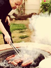 Man preparing food on barbecue grill