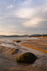 Scenic view of beach against sky during sunset