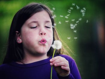 Close-up of girl holding flower