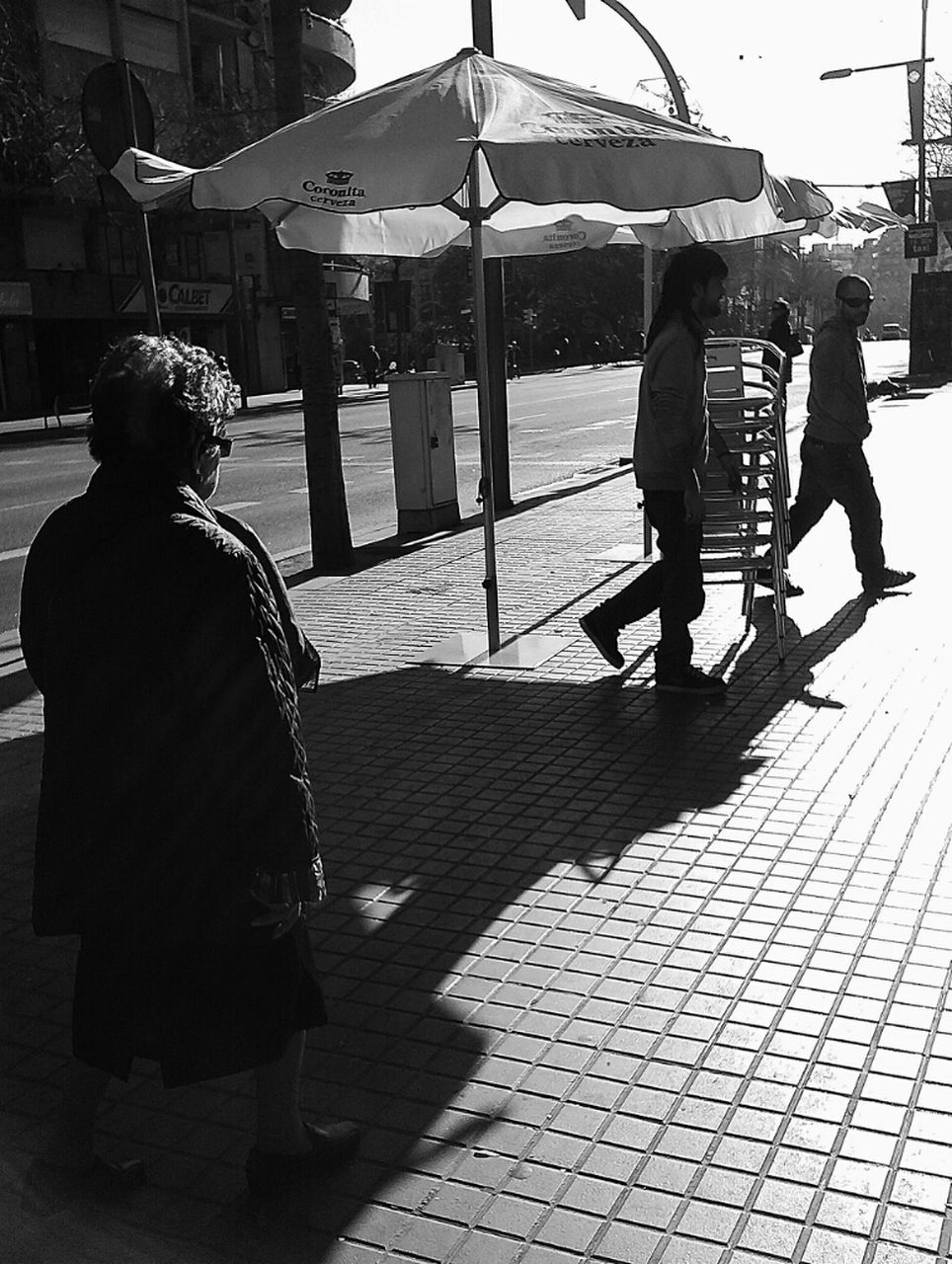 men, lifestyles, person, rear view, leisure activity, full length, walking, sunlight, shadow, sitting, city life, city, street, togetherness, casual clothing, medium group of people, transportation