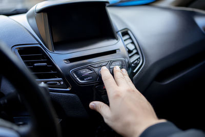 Midsection of man driving car