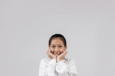 Portrait of cute girl against white background