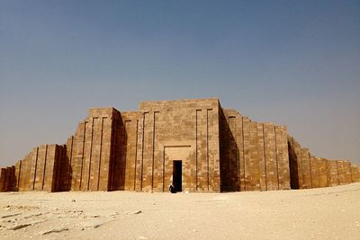 Low angle view of built structure against clear blue sky