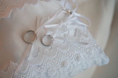 Close-up of rings on white fabric