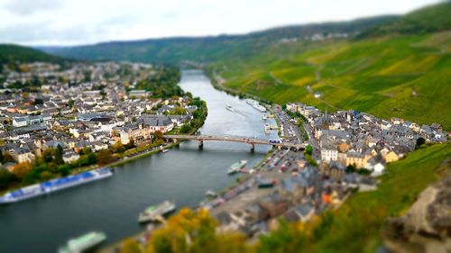 High angle view of river by cityscape against sky