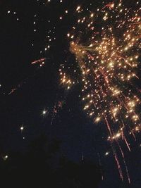 Low angle view of firework display at night