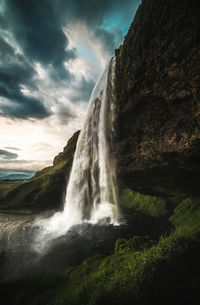 Scenic view of waterfall against sky