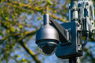 Low angle view of camera against trees