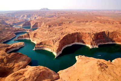 Lake by rock formations against clear sky