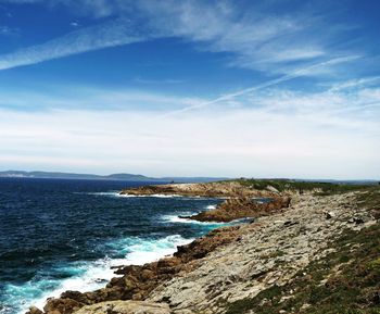 Scenic view of sea against cloudy sky