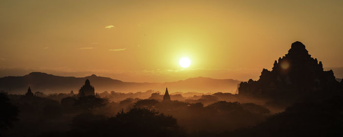 Silhouette of temple against sky during sunset