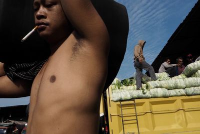 Midsection of shirtless man and woman