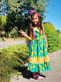 Portrait of smiling girl standing against plants