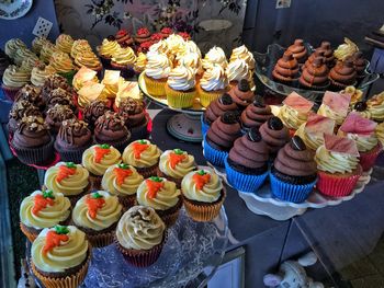 High angle view of cupcakes in plates on table