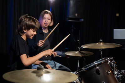 Young woman playing drum