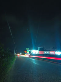 Light trails on road in city at night