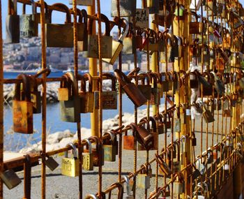 Padlocks hanging on rusty railing