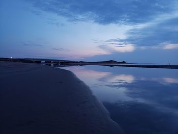 Scenic view of sea against sky at sunset on beach