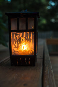 Close-up of lit candles on table