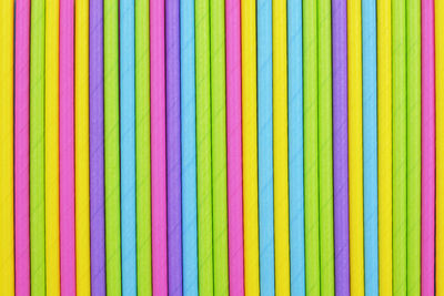 Colored paper straw pattern background. flat lay cocktail tube abstract vertical line texture