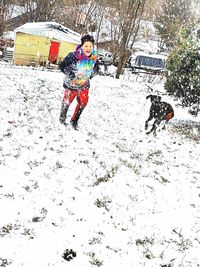 People playing with dog during winter