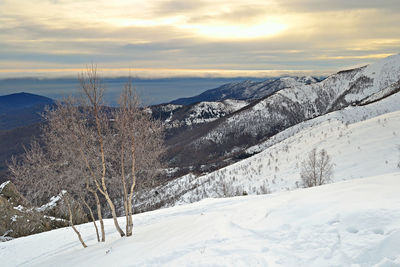 Scenic view of snow covered mountains against sky