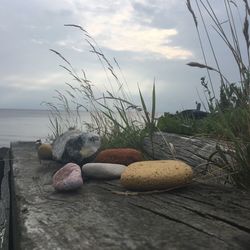 Rocks by sea against sky