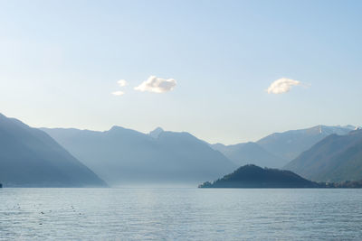 Scenic view of sea and mountains against sky