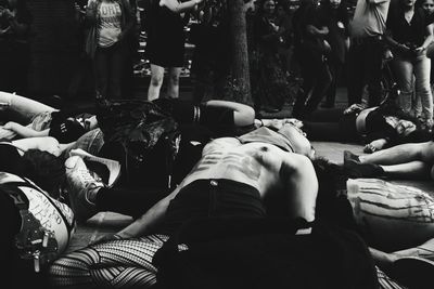 Rear view of people relaxing on floor