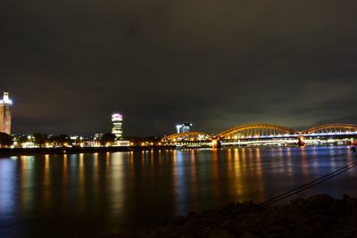 Illuminated city at waterfront at night