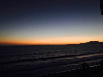 Scenic view of sea against clear sky during sunset