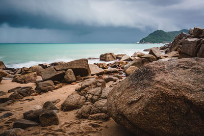 Rocks on beach against sky