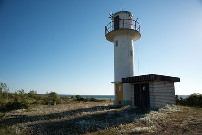 Lighthouse against clear blue sky