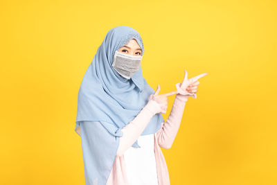 Portrait of woman with yellow umbrella