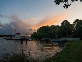 Scenic view of river against sky at sunset