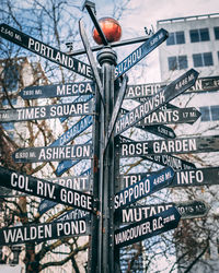 Close-up of information sign on wall by building