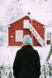 Rear view of man standing in snow